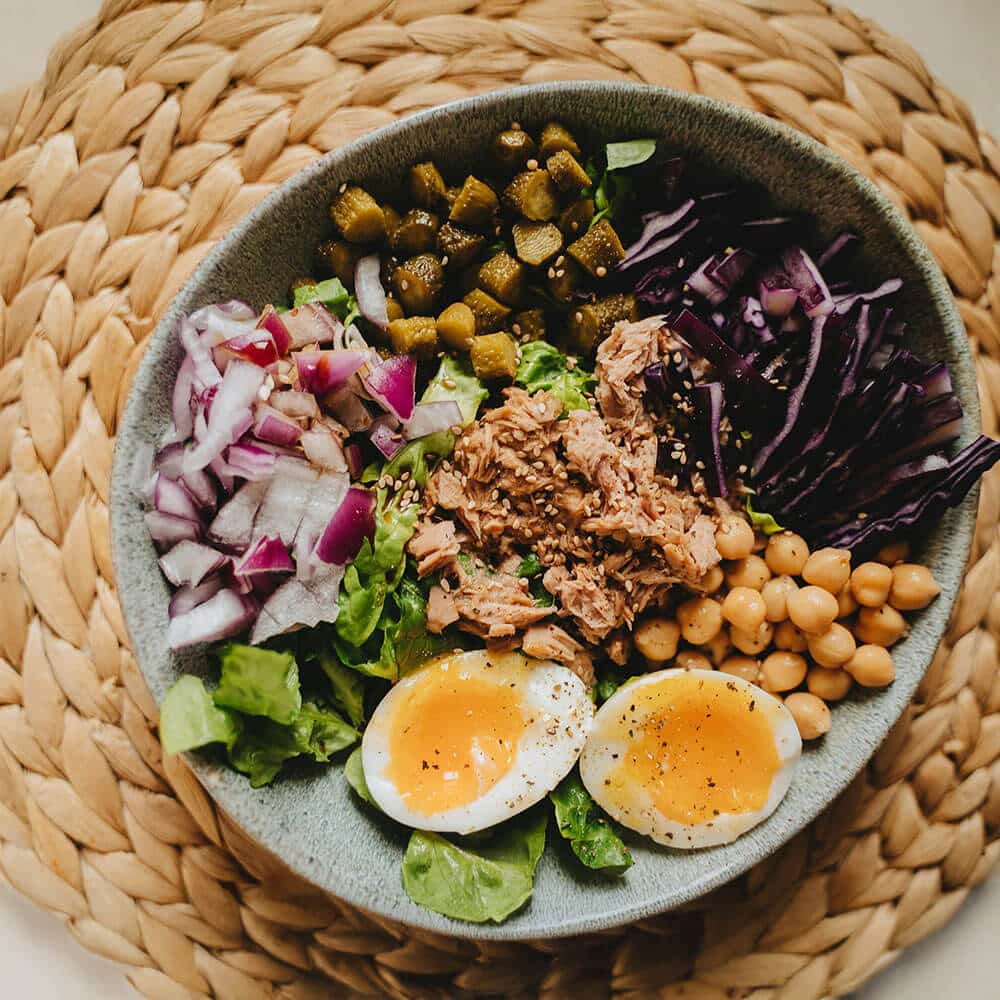 Fresh salad bowl featuring tuna, eggs, and crisp vegetables, representing the farm-to-fork freshness ensured by T. Wilson & Sons temperature-controlled transport.