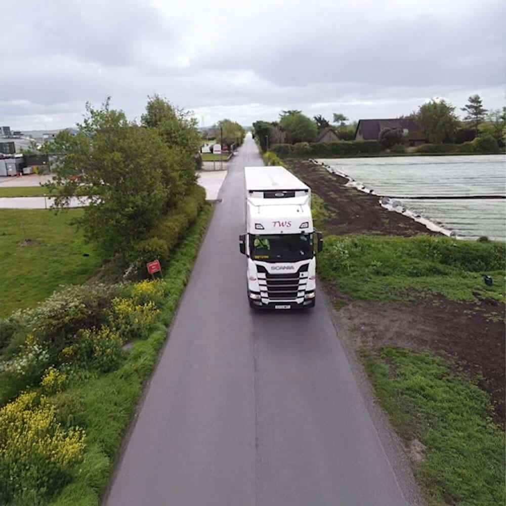 T. Wilson & Sons low-emission Scania truck transporting temperature-controlled goods from rural farms, illustrating the link between green logistics and ULEZ compliance.